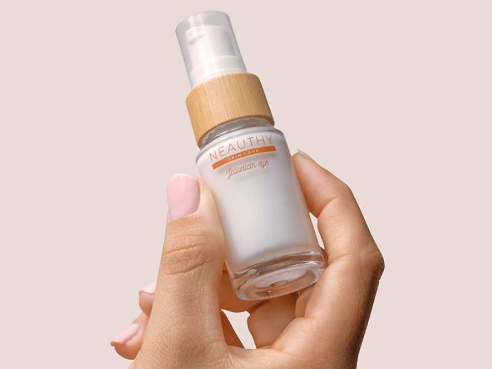 Hand Holding Cosmetics Bottle